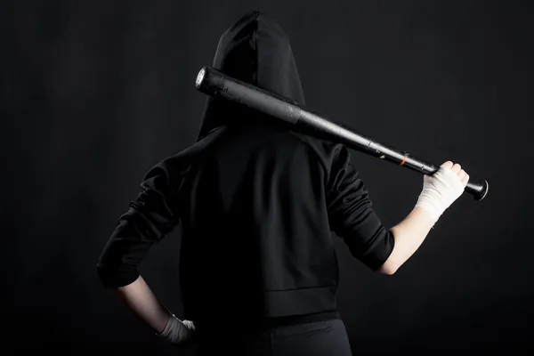 Young woman with a baseball bat. View from the back. hoodlum — Stock Photo, Image