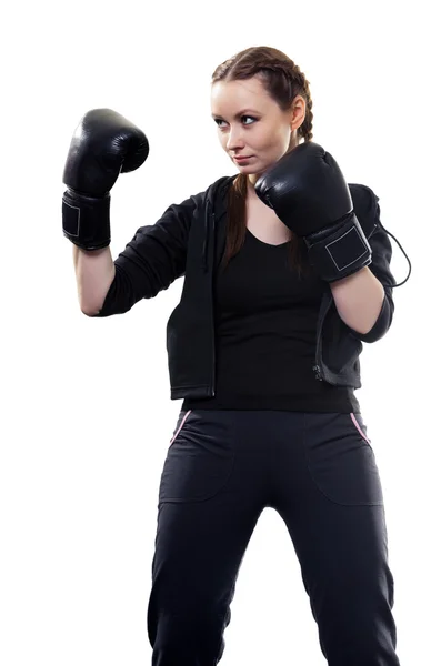 Mujer joven en guantes de boxeo sobre un fondo blanco — Foto de Stock