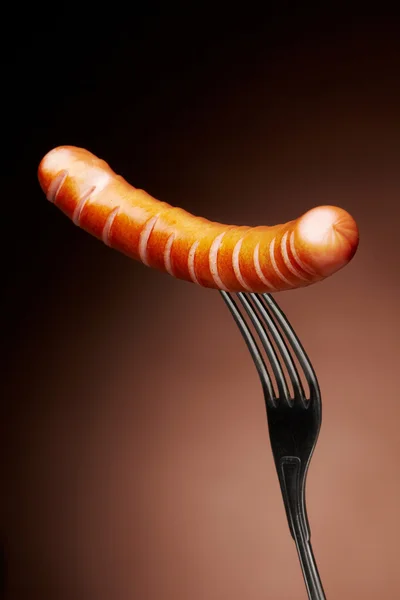 Grilled sausage on a fork — Stock Photo, Image