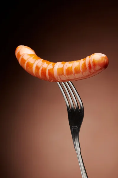 Grilled sausage on a fork — Stock Photo, Image