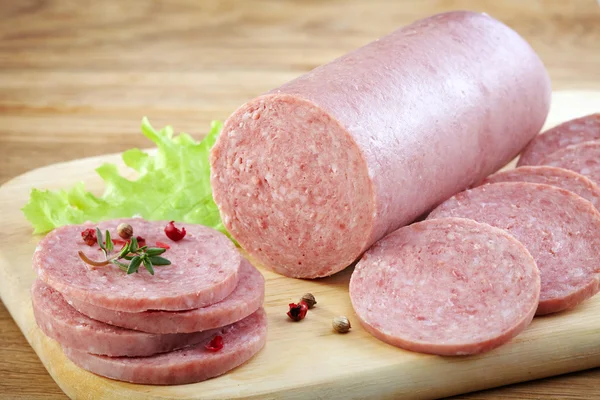 Salami sausage on wooden cutting board — Stock Photo, Image