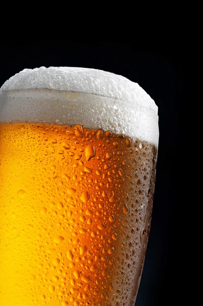 Glass of beer on dark blue background — Stock Photo, Image