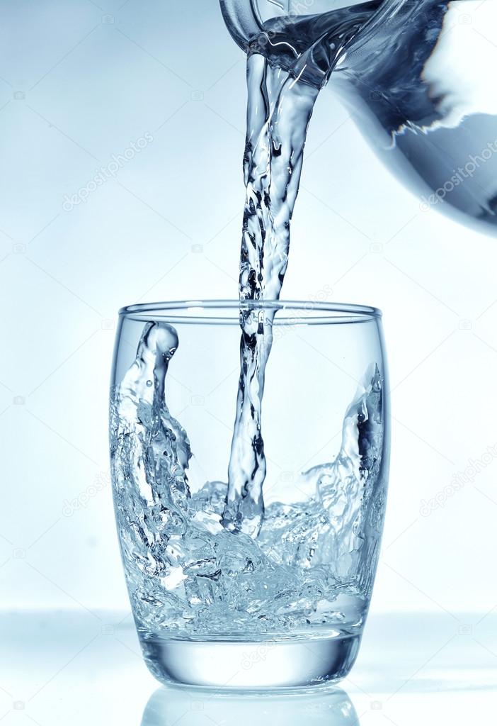 Fresh water pouring into glass