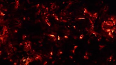 Yanan ateş közleri, canlı kömürler, arka plan dokusunda yanan kömür, yakın plan, parlayan kömür. Üst Manzara. 4K UHD video görüntüsü 3840X2160.