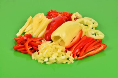 Fresh sliced paprika, Bell Pepper, isolated on green background. High resolution photo. Full depth of field.