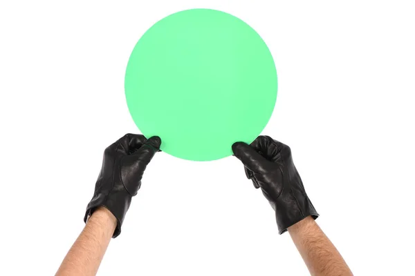 身穿黑色皮手套的男子白色背景 手上拿着绿色的圆圈作题词 侧视图 高分辨率照片 实地的全部深度 — 图库照片