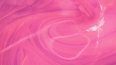 Mixing pink paint. Beautiful divorces of paint of an abstract form are visible. Top view. 4K UHD video footage 3840X2160.