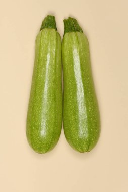 Perfectly retouched zucchini isolated on beige. High resolution photo. Full depth of field.