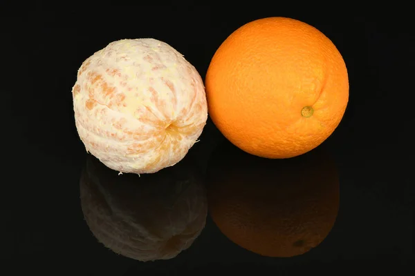 Perfectly retouched orange isolated on acrylic black background. High resolution photo. Full depth of field.