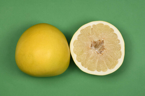 Perfectly retouched pomelo on green background. High resolution photo. Full depth of field.