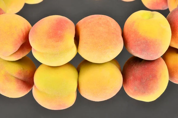 Ripe peaches isolated on mirror background. High resolution photo. Full depth of field.