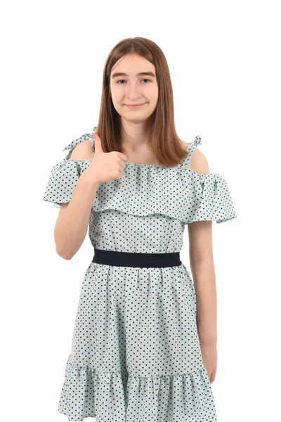 穿着蓝色衣服的年轻漂亮姑娘 白色背景上有圆点 对着相机笑着 竖起大拇指 — 图库照片