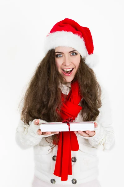 Beautiful happy woman in a Christmas hat holding a gift — Stock Photo, Image