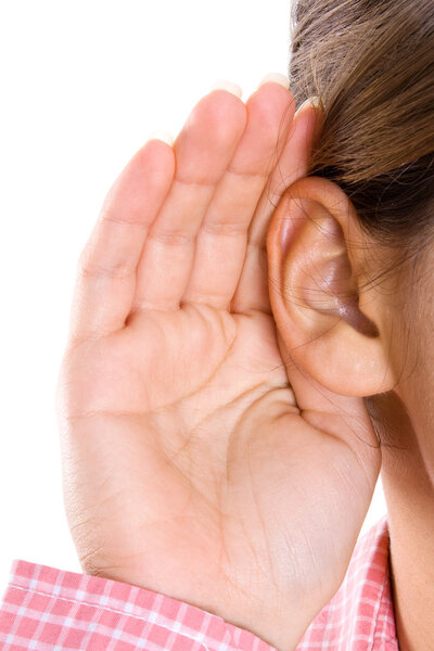 Girl listening with her hand on an ear