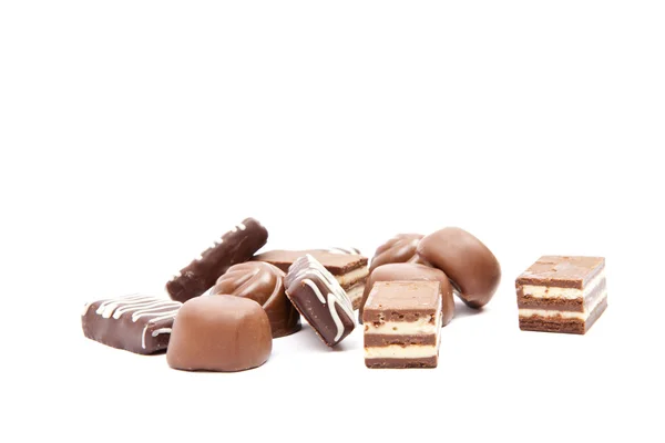 Chocolates heap against — Stock Photo, Image