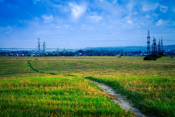 Beautiful spring field with the blue sky — Stock Photo, Image