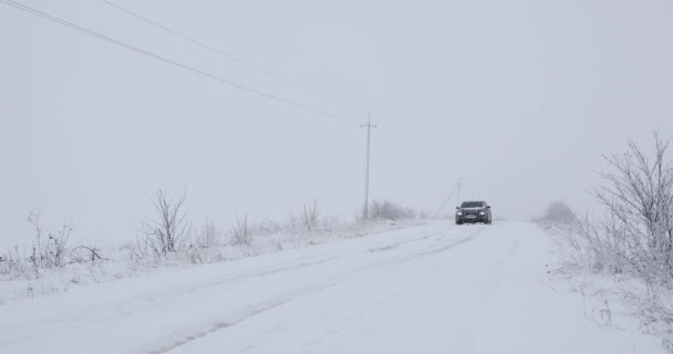 UKRAINE, ROVNO - 13. prosince: auto projede zasněženou cestou — Stock video