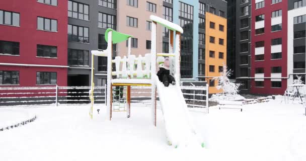 Crianças brincam com neve no parque infantil — Vídeo de Stock