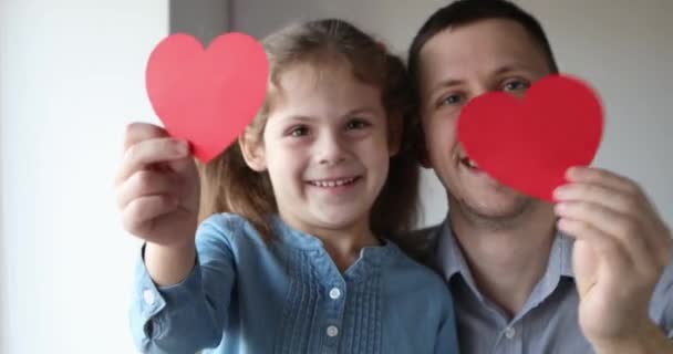 Smiling little child with a postcard in his hands — Vídeo de stock