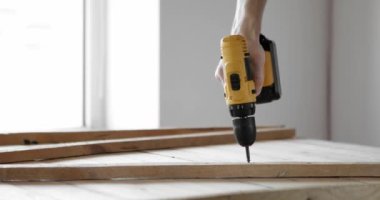 Üniformalı tamirci otomatik tornavidayla çalışır..