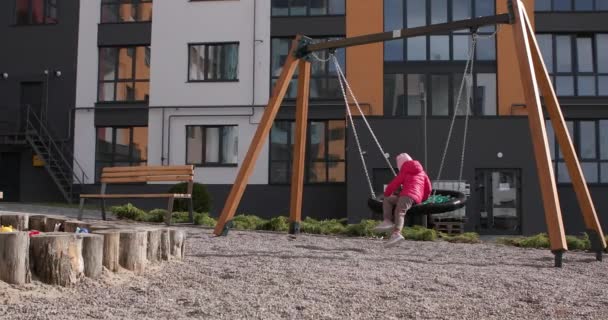 Girl on a swing in the playground — Stock Video