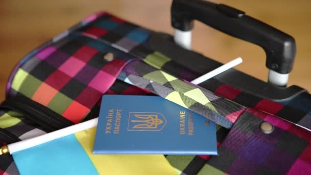 The passport of Ukraine and the national flag blue and yellow on the bag — стоковое видео