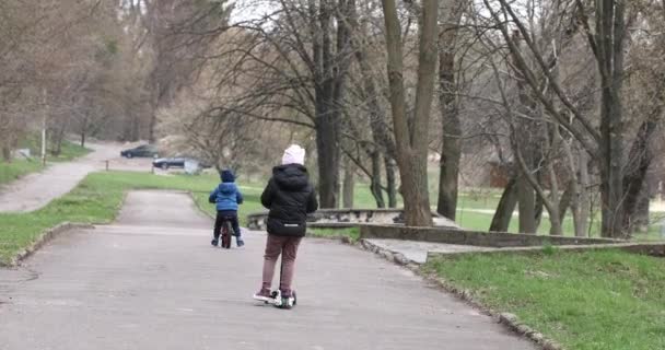 Ребенок ездит на велосипеде осенью в парке — стоковое видео
