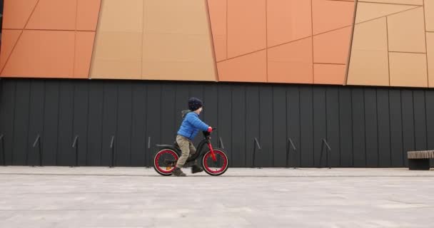 Boy riding a bike on the street — Video Stock