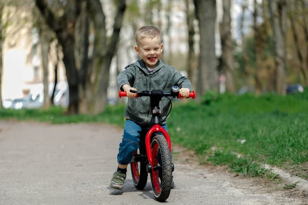 Chico montando una bicicleta en la calle. Aprender a montar en bicicleta concepto — Foto de Stock