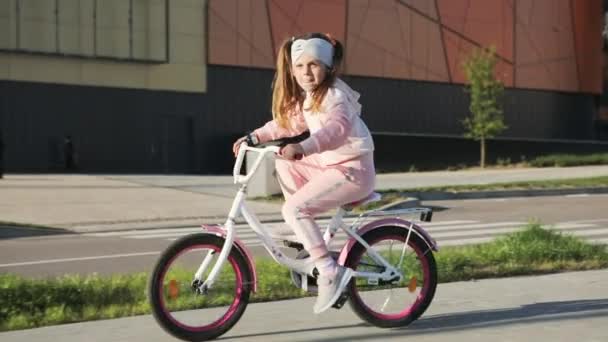 Little girl on a bicycle in summer park. cycling outdoors — Wideo stockowe