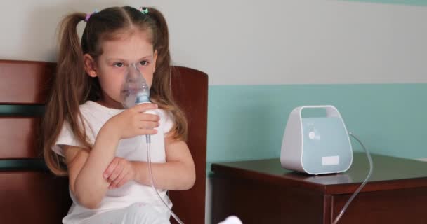 Girl making inhalation with nebulizer at home. — Video