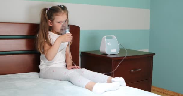 Girl making inhalation with nebulizer at home. — Video