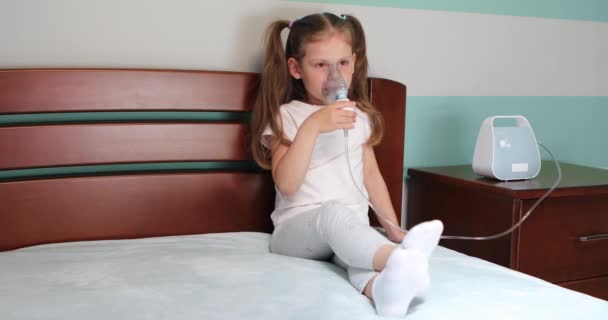 Girl making inhalation with nebulizer at home. — Stockvideo