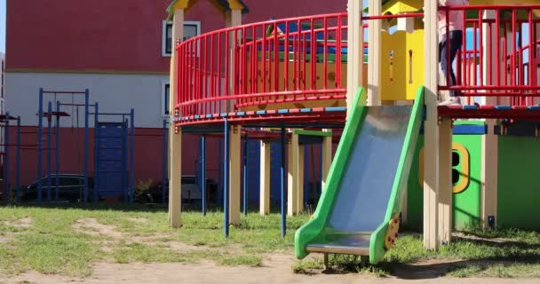 Child swinging on playground on sunny summer day in a park. — Stock Video