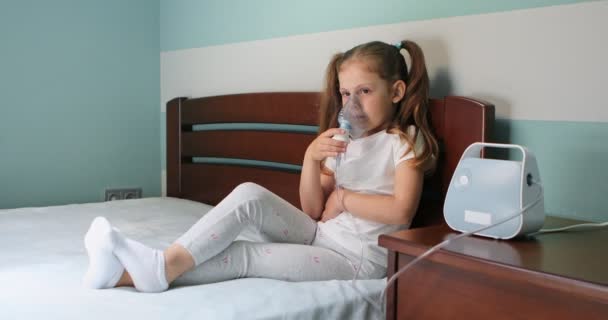 Girl making inhalation with nebulizer at home — Stock video