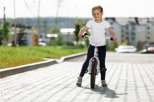 Bambina in bicicletta nel parco estivo . — Foto Stock