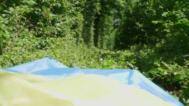 yellow and blue ukrainian flag at railway station immigration refugee. High quality FullHD footage