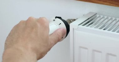 Man hand changing the temperature on the radiator by temperature controller. High quality 4k footage