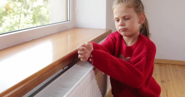 Little Girl Warms Her Hands Feet Radiator High Quality Footage — Vídeo de stock