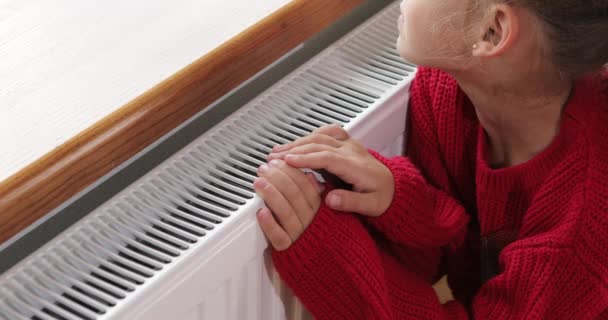 Little Girl Warms Her Hands Feet Radiator High Quality Footage — Stockvideo