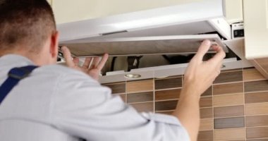 repairman cleaning a kitchen hood air filter. High quality 4k footage