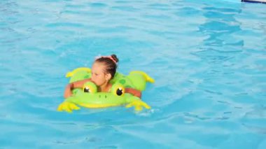 smiling girl in swimming pool, child is playing. Summer vacation or classes. Summertime and swimming activities for happy children on the pool. High quality FullHD footage