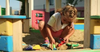 boy and girl playing in the playground on a summer day. High quality 4k footage