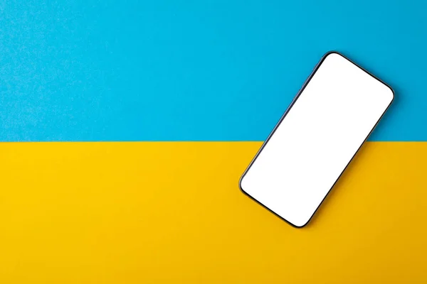 empty screen mobile phone on the background of the flag of ukraine.