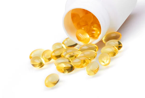 Yellow pills and pill bottle — Stock Photo, Image