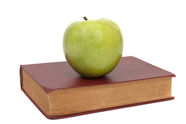 Gammal bok och green apple — Stockfoto