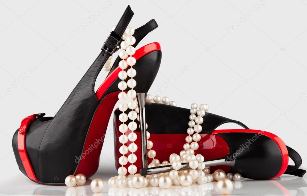 high-heeled shoes and a pearl necklace