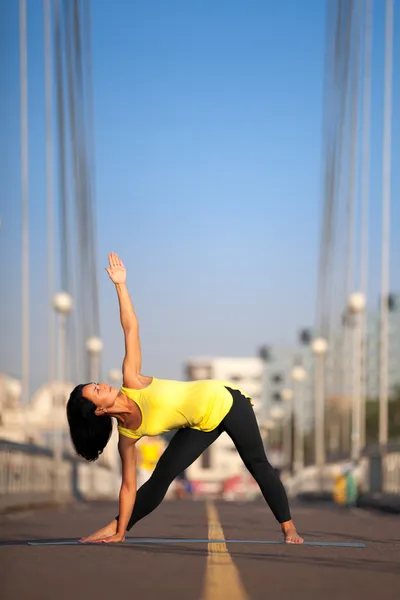 Woman doing stretching yoga exercises outdoors — Stock Photo, Image