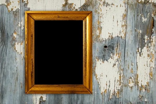 Gold frame on a old wooden wall background. — Stock Photo, Image