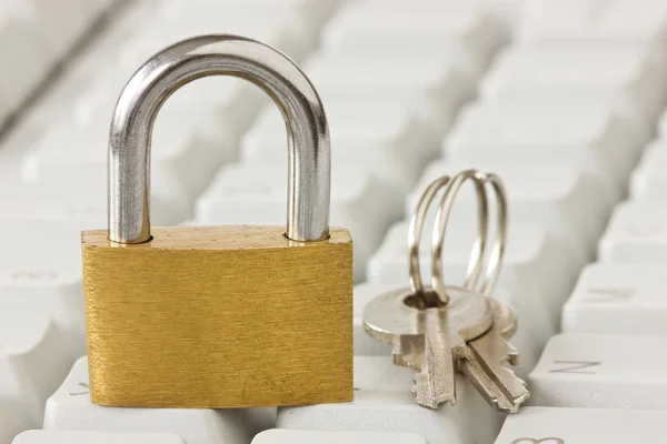 Padlock with a keys on keyboard — Stock Photo, Image